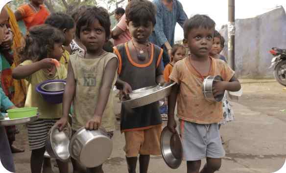 Children holding plates at a meal distribution