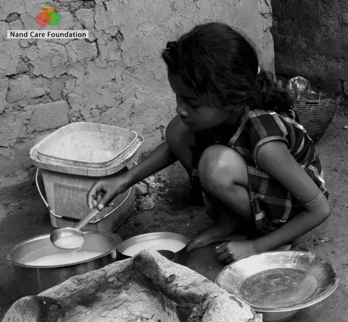 A young girl serving food at home in a rural community