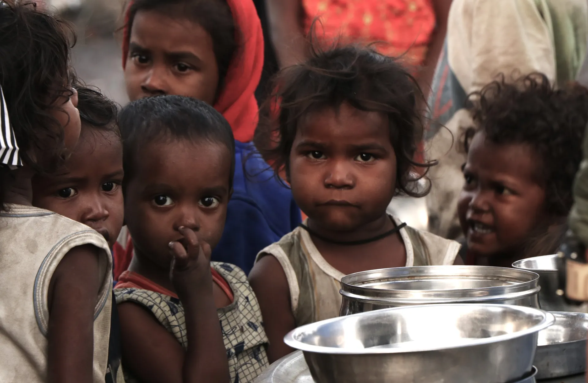 Children gathered with bowls waiting for a meal