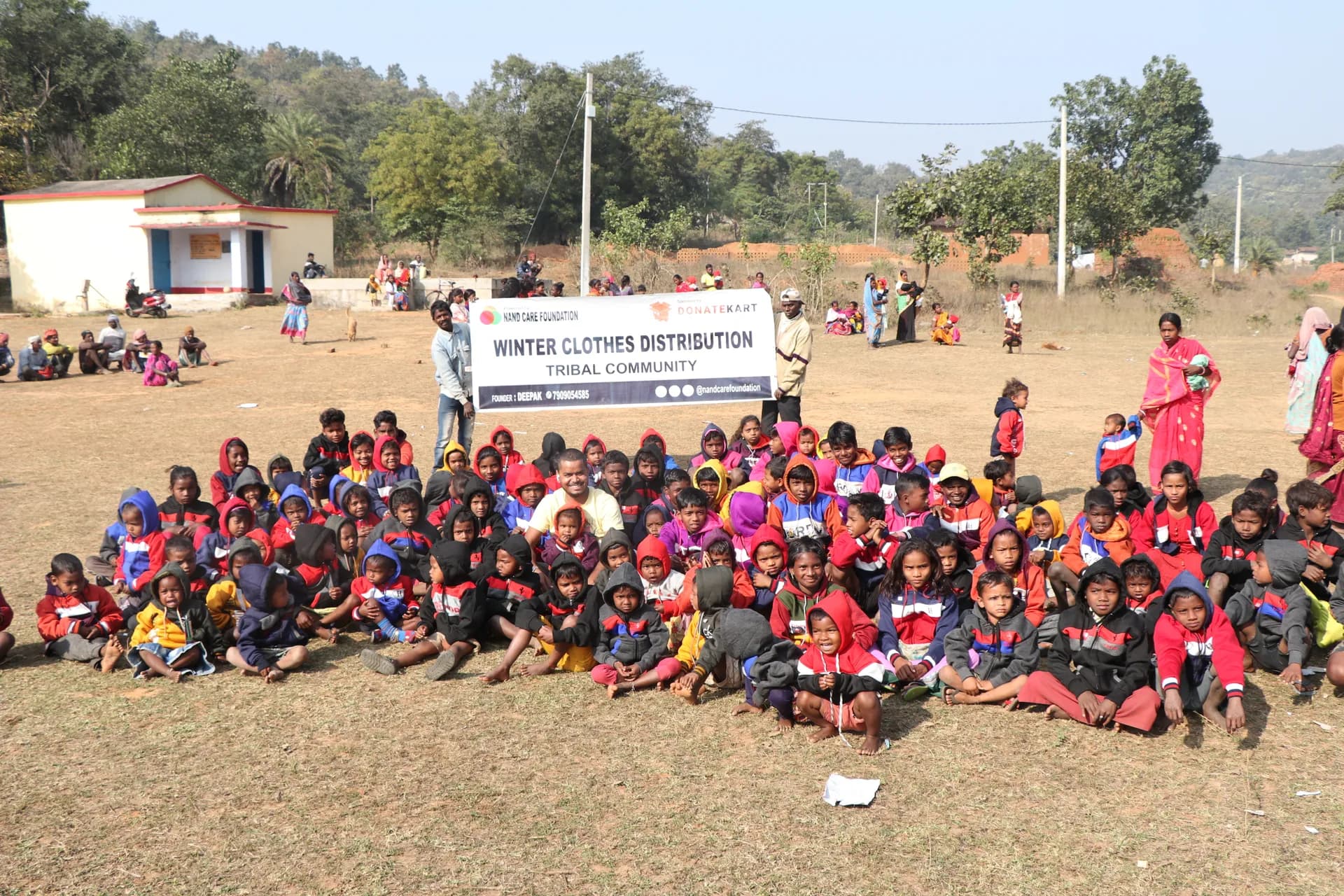 Hundreds of children seated for a winter clothes distribution