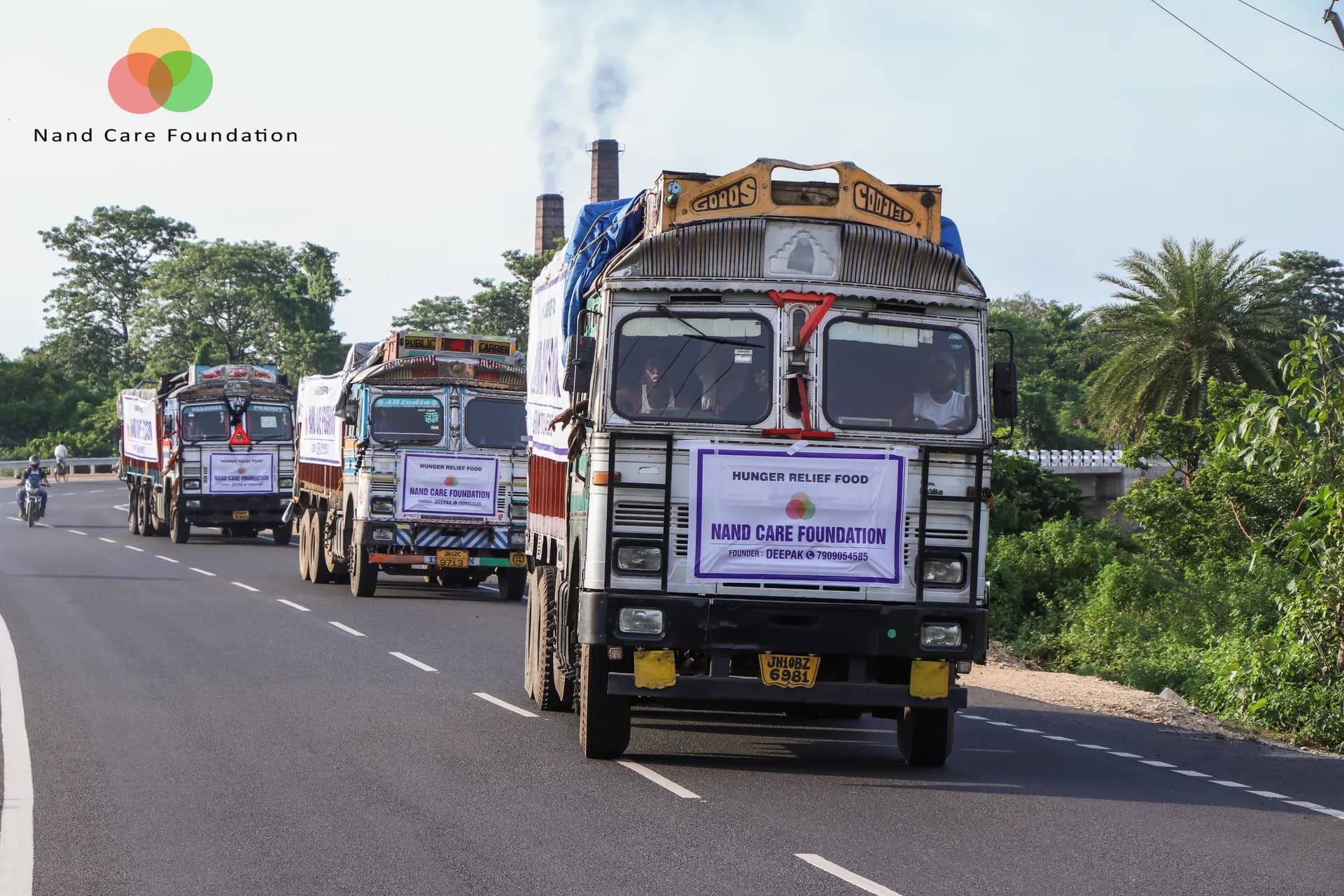 Relief trucks carrying ration kits on the road to villages