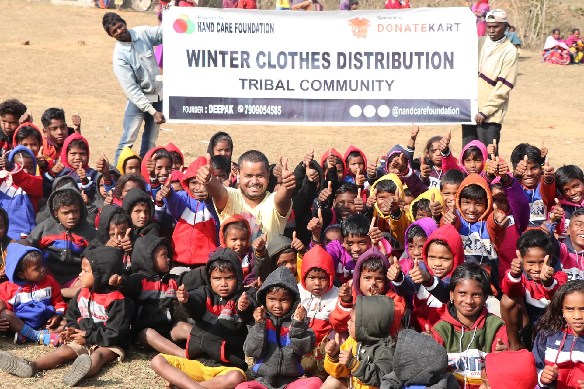 Children cheering at a winter clothes distribution for the tribal community